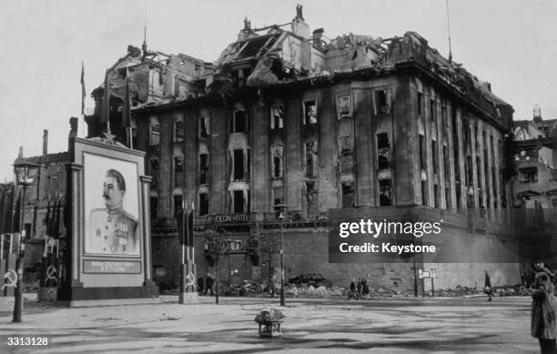 The damaged Adlon Hotel on the Unter Den Linden in Berlin, next to a vast picture of Stalin erected by the Russians.