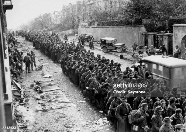 Hundreds of German prisoners line the streets after the final surrender of Aachen, Germany.
