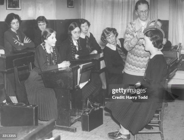 Phrenologist Amy B. Barnard, L.L.A. , F.B.P.S. Uses a craniometer to measure the skull of a new pupil at Braemar High School in Tooting, south...