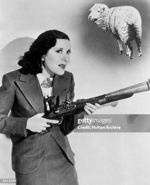 American actress Gracie Allen gets her gun in the Paramount production 'College Swing' , directed by Raoul Walsh.