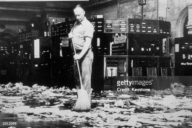 Cleaner sweeping the dealing floor of the New York Stock Exchange.