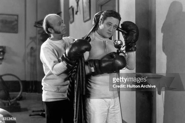 Lucien Littlefield and Edmund Lowe in a scene from the US film 'The Reason Why'.