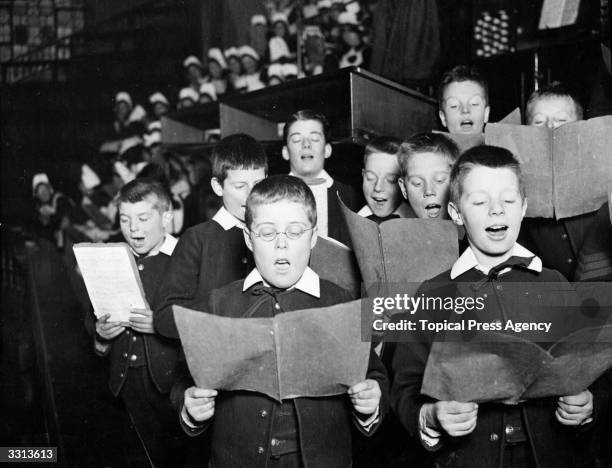 Choir boys singing Christmas carols at a foundling hospital.