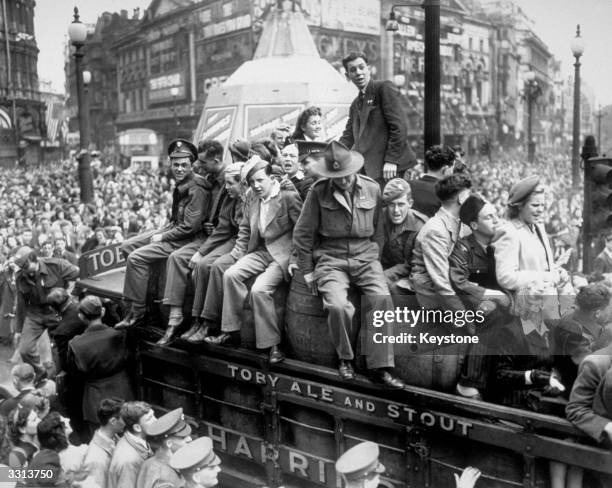 Van load of beer passing through Piccadilly Circus on VE Day. The statue of Eros, protected during the war by advertising hoardings, can be seen in...