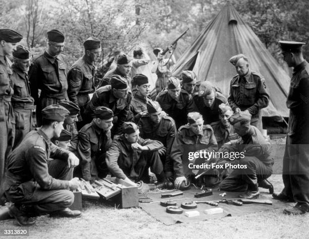 Members of the Home Guard at a training camp learn how a Tommy gun is constructed.
