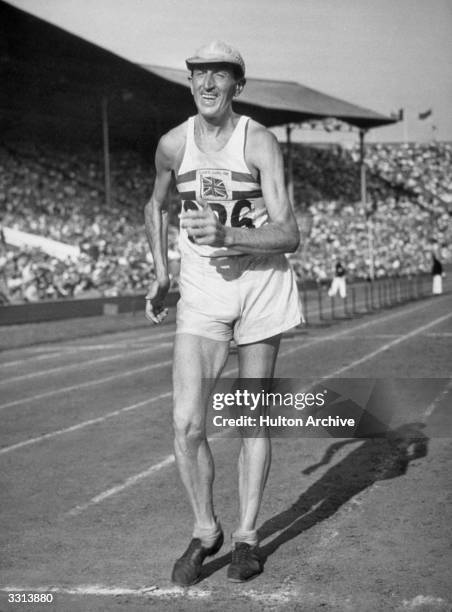 Tebbs Lloyd-Johnson of Great Britain finishes third in the 50 kilometres Road walk at the 1948 London Olympics, Wembley Stadium. At 48 years old he...