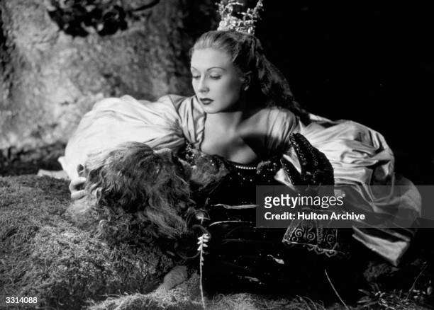 French actress Josette Day kneels over the stricken Beast, played by Jean Marais in Jean Cocteau's beautifully surreal film 'La Belle Et La Bete',...