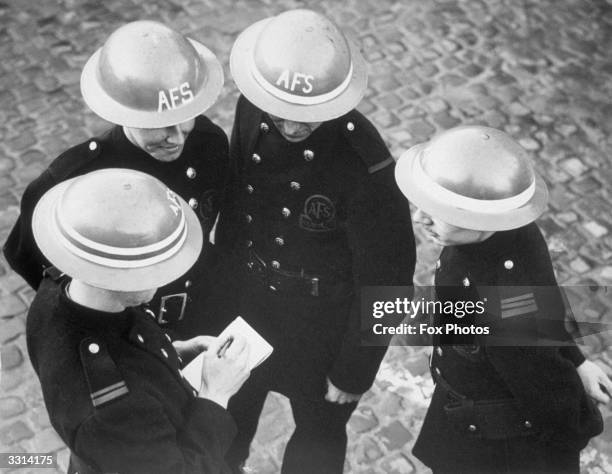 Officers in the auxiliary fire service have rings painted on their steel helmets in order to denote their rank.