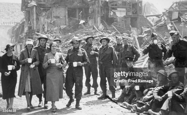 Refugees who lost their homes after an air raid on Canterbury, receive a helping hand from the army.