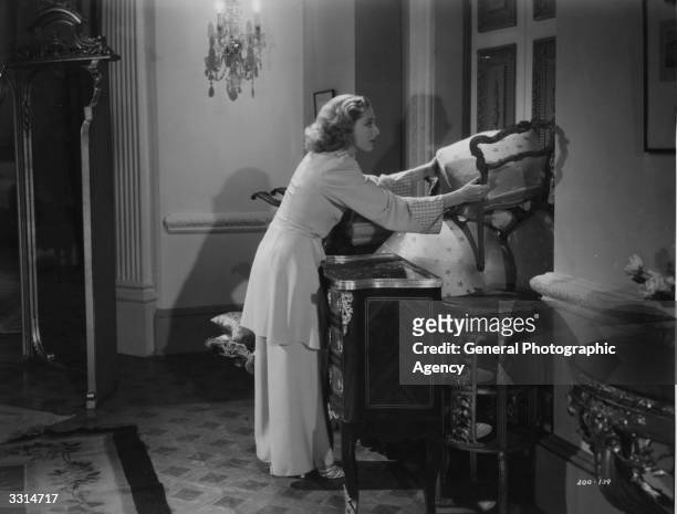 Diana Churchill barricading her door in the film 'Jane Steps Out'.