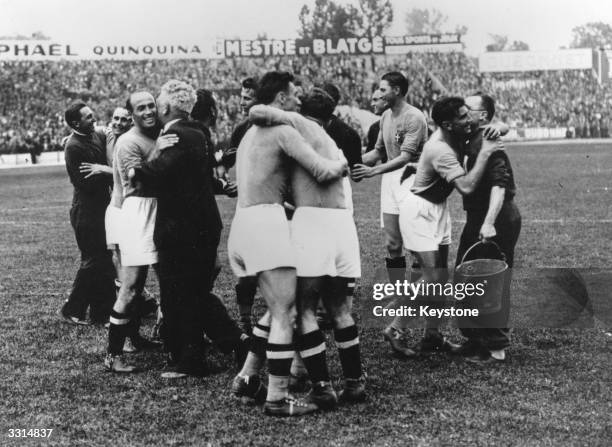 Members of the Italian football team embracing each other, at the end of their 4-2 victorious World Cup final against Hungary in Paris.