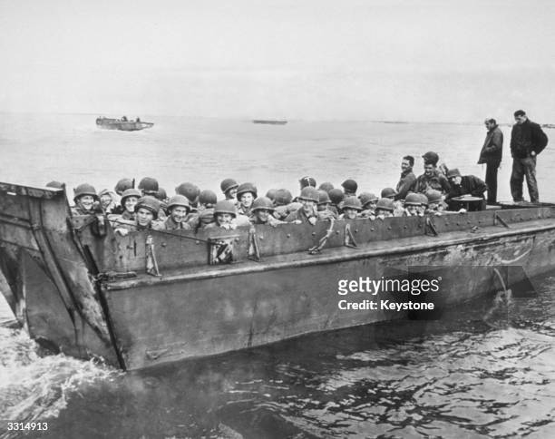 American soldiers on a landing craft on their way to the Normandy beaches, during the invasion of Europe.
