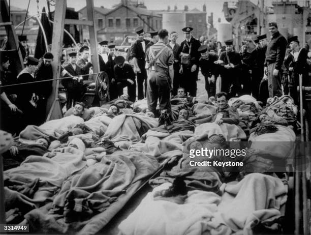 Wounded soldiers arrive back in England from the Normandy beaches.