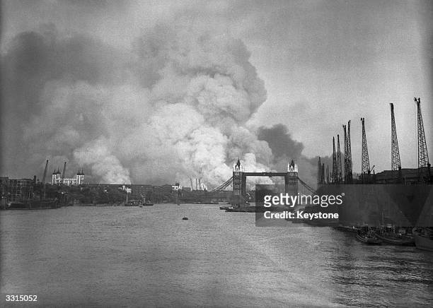 View east down the Thames towards smoke rising from fires in Surrey docks, following the first German air raid of the London Blitz, 7th September...