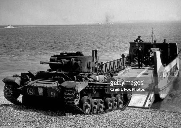 Valentine tank climbs the beach after leaving the landing craft during an invasion exercise in the run-up to D-Day.