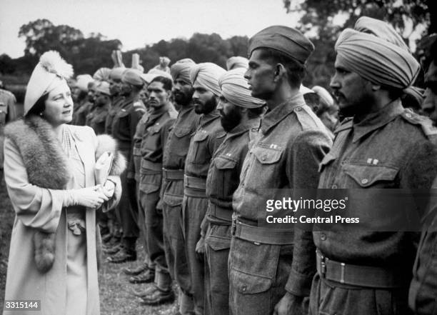 Queen Elizabeth , Queen Consort to King George VI visiting soldiers released from German prisoner-of-war camps and resting in Britain on their way...