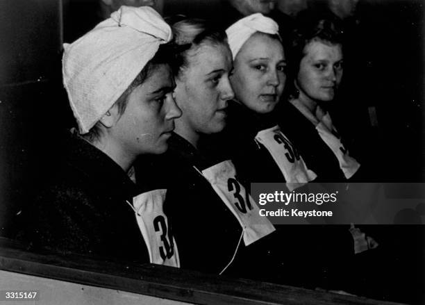 Four female guards photographed in the dock during the Belsen trial for concentration camp atrocities, in Luneburg. Left to right: Charlotte Klein,...