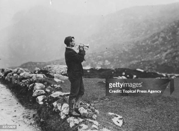 An Icelander blows his bugle for echoes in the mountains.