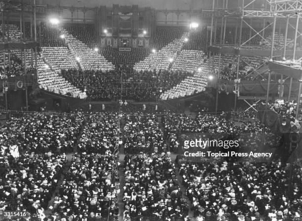 Children singing the national anthem in front of a huge audience for the Festival of Empire at Crystal Palace, London.