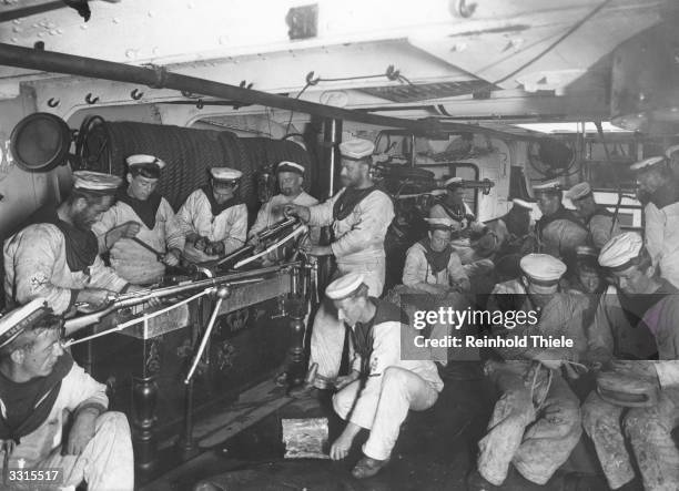 Armourers and gunsmiths inspecting weapons on board the cruiser, the HMS 'St George', built in 1892.