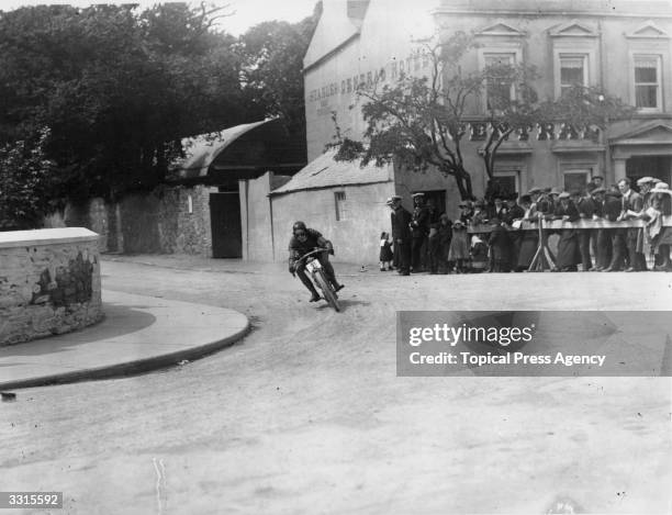 Mr A Kirk rounds the corner by the Central Hotel in Ramsey Town on a 3.5 Triumph motorcycle, during the Isle of Man Senior Tourist Trophy Race.