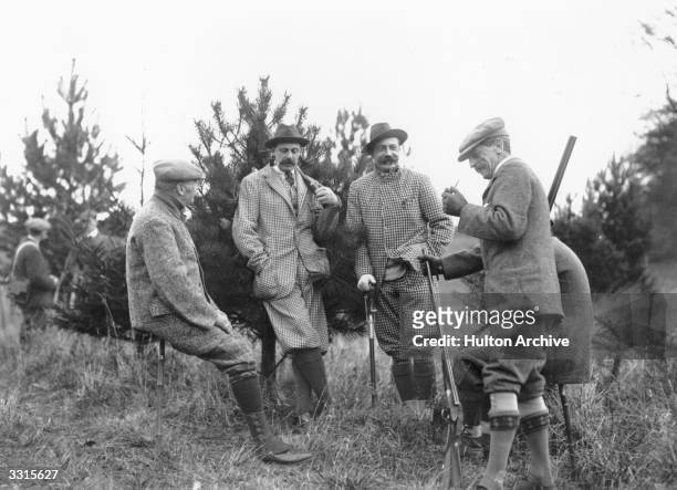 Group of Edwardian gentleman relaxing on a pheasant shoot.
