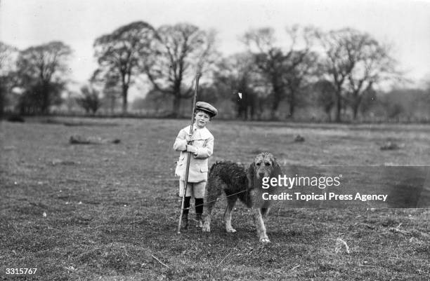 Child with an otter hound prepares to join a meet near Dumfries. Otter hounds have been bred for hunting since the 12th century. The animals, also...