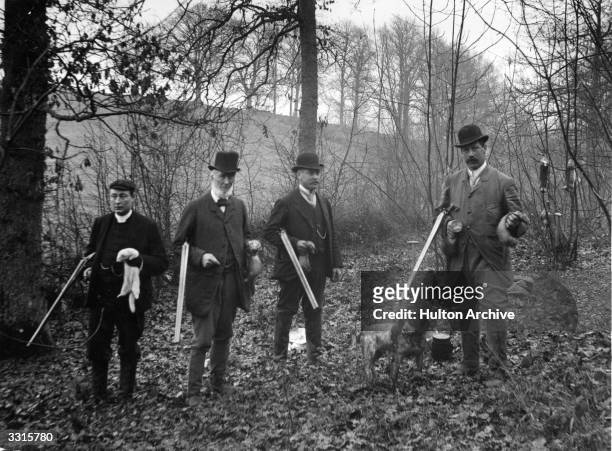Four men on a rabbit shoot, with ferrets to flush out their quarry from their burrows.
