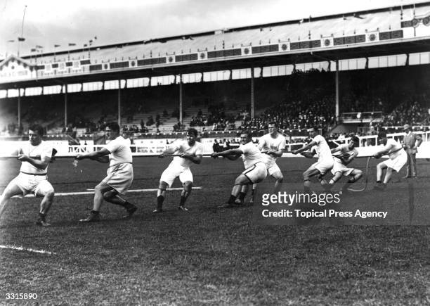 The Unites States tug-of-war team in action during the 1908 London Olympics at White City Stadium.
