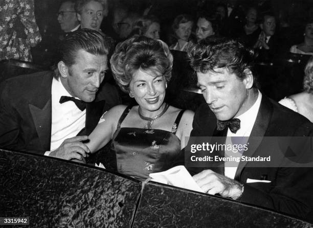 American actor Kirk Douglas with his wife and Burt Lancaster at the first night of 'Auntie Mame'.