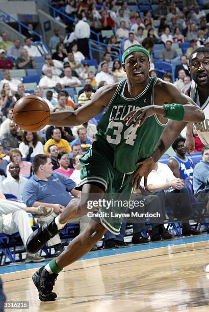 Paul Pierce of the Boston Celtics drives around Robert Traylor of the New Orleans Hornets April 9, 2004 at the New Orleans Arena in New Orleans,...