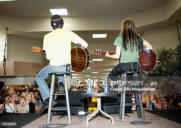 Music star Avril Lavigne and Evan Taubenfeld perform at Avril's "Top Secret Mall Tour 2004" on April 9, 2004 at Southland Mall, in Hayward,...
