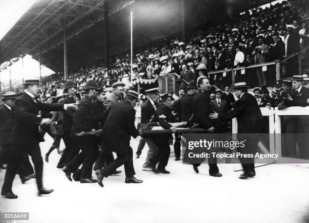 Dorando Pietri of Italy is stretchered away after collapsing in the Marathon at the 1908 London Olympics. Despite finishing first, he was...