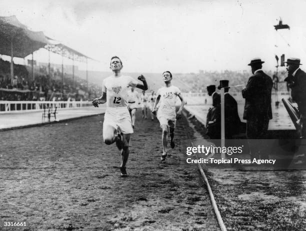 Melvin Sheppard of the USA crosses the finish line to win the final of the 1500 Metres at the 1908 London Olympics from Harold Wilson of Great...