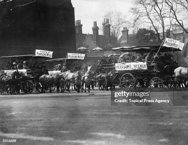 Football supporters on horse-drawn buses in London for the FA Cup Final between Barnsley and West Bromwich Albion.