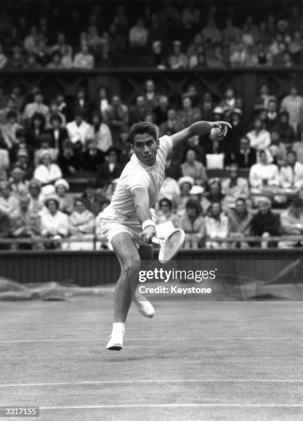 Spanish tennis player Manuel Santana in action against Tony Roche of Australia at Wimbledon.