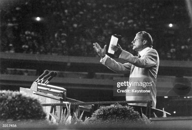 Evangelist Billy Graham addressing a meeting.