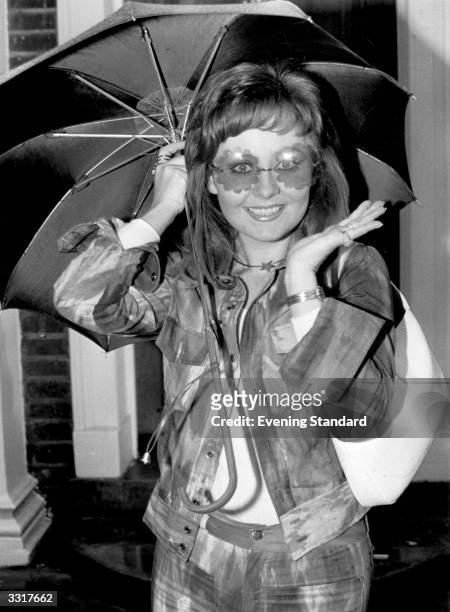 British pop singer Lulu wearing a fashionable pair of suglasses on her way from her home in Highgate, north London, to Heathrow Airport for a flight...