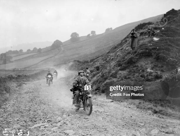 Competitors in the Internationality Reliability Trials in Buxton, Derbyshire negotiating a rough country track.