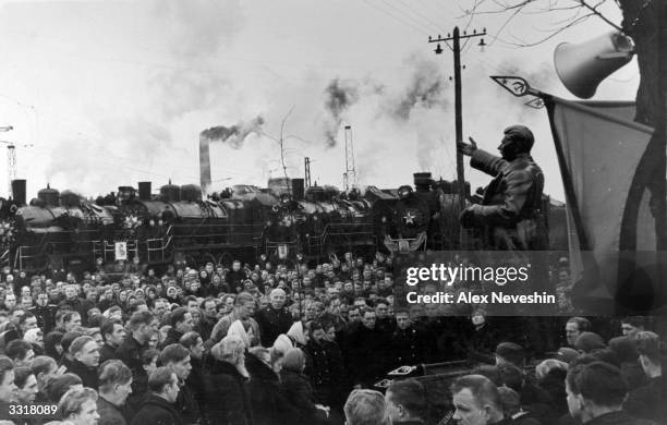 Locomotive depot workers mourning Stalin's death in front of his statue.