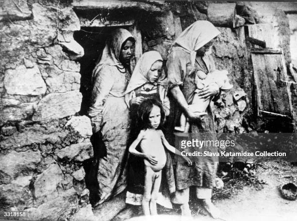 Family stricken by famine in the Volga region, Russia, during the Russian Civil War. Most of the regions adjacent to the Volga river were affected by...