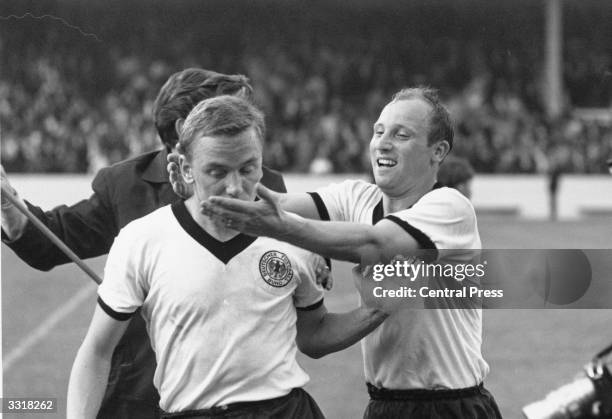 German footballer Uwe Seeler rushes to embrace teammate Werner Kramer after victory over Spain in a World Cup match at Villa Park, Birmingham. Seeler...