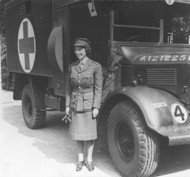 Princess Elizabeth, standing by an Auxiliary Territorial Service first aid truck wearing an officer's uniform.