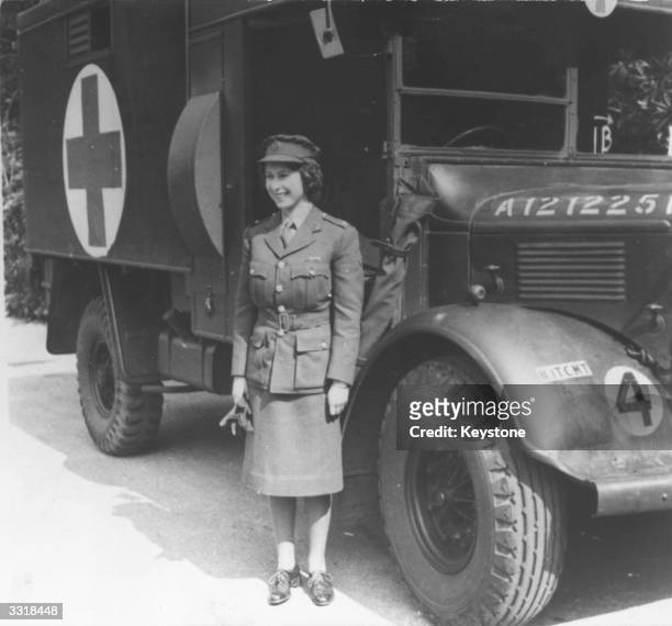 Princess Elizabeth, standing by an Auxiliary Territorial Service first aid truck wearing an officer's uniform.