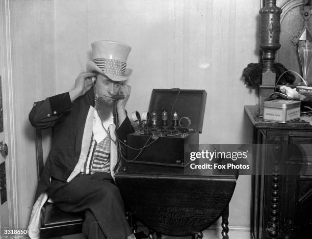 'Uncle Sam' listening to a large ' valve' wireless.