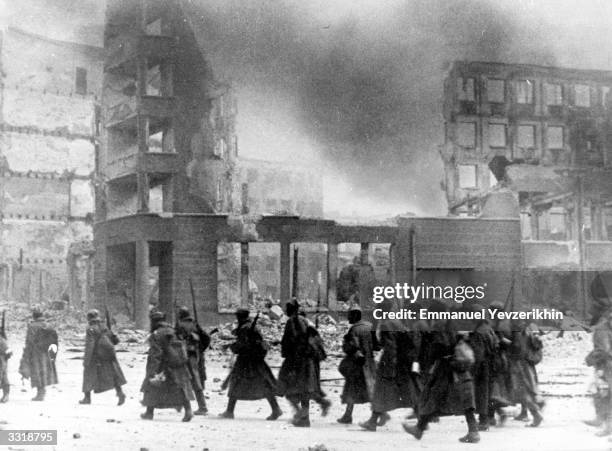 Russian troops in the centre of bomb-damaged Stalingrad, Russia. They are in front of the destroyed department store in which German Field Marshal...