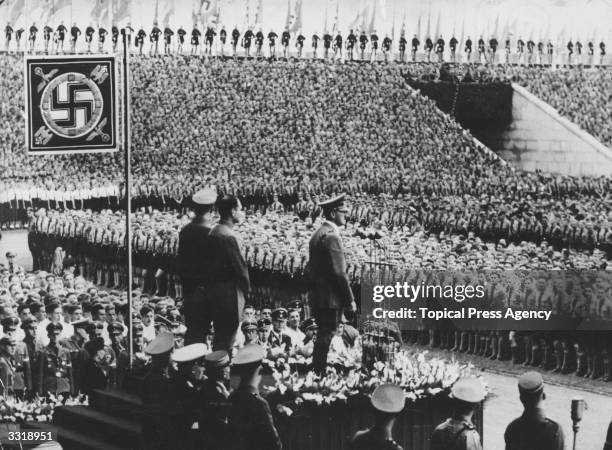 Nazi German dictator Adolf Hitler addresses members of the Hitler Youth Movement at Nuremberg. Behind the Fuhrer are Baldur Von Schirach , leader of...