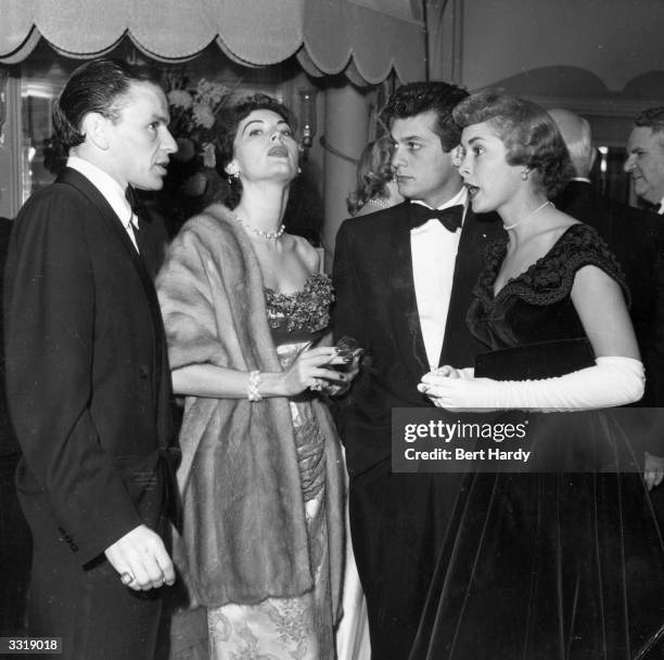 Frank Sinatra and his wife, Ava Gardner with Tony Curtis and his wife Janet Leigh at a party hosted by the Duke of Edinburgh for friends and members...