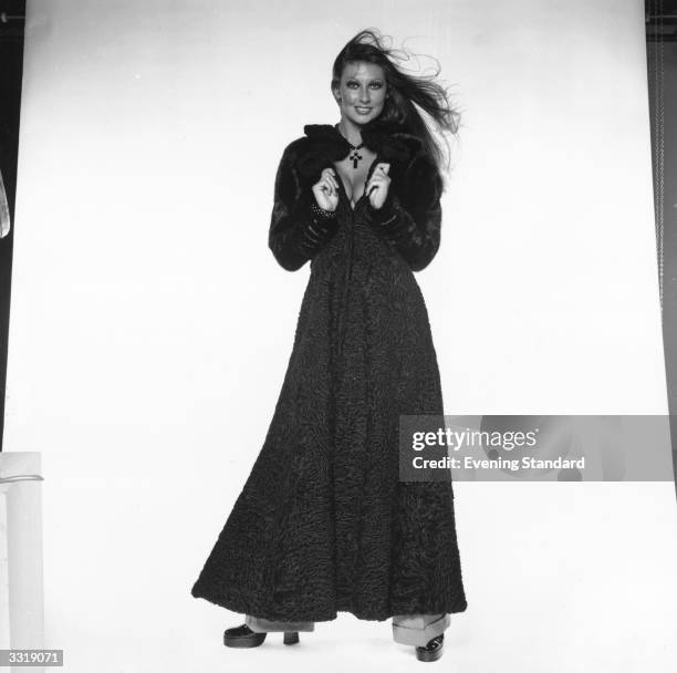 Model Marilyn Cole modelling a full-length coat.