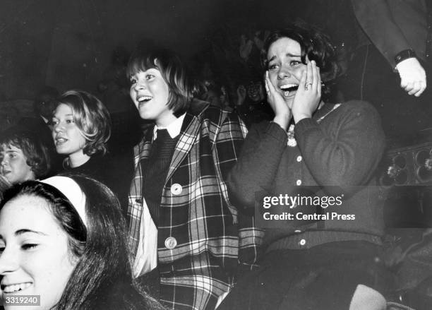 View of audience members during a performance, by the Beatles, on the 'The Ed Sullivan Show' at CBS's Studio 50, New York, New York, February 9, 1964.